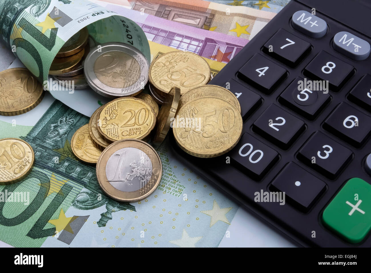 Euro (EUR) notes, coins, and a calculator Stock Photo - Alamy