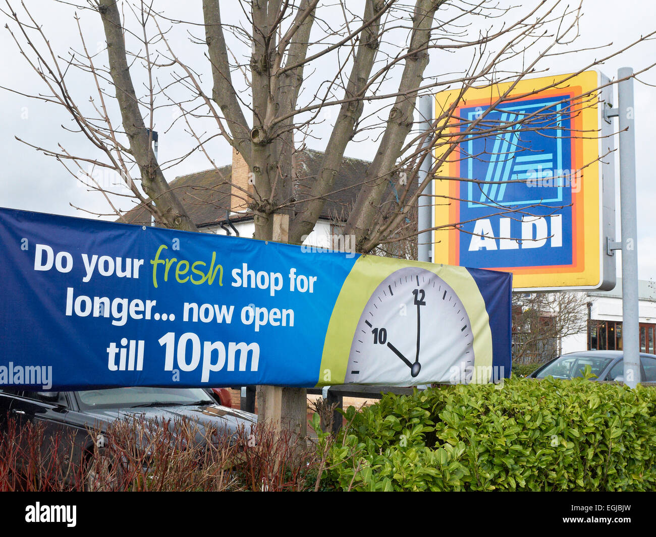 Aldi open longer hours banner UK Stock Photo Alamy