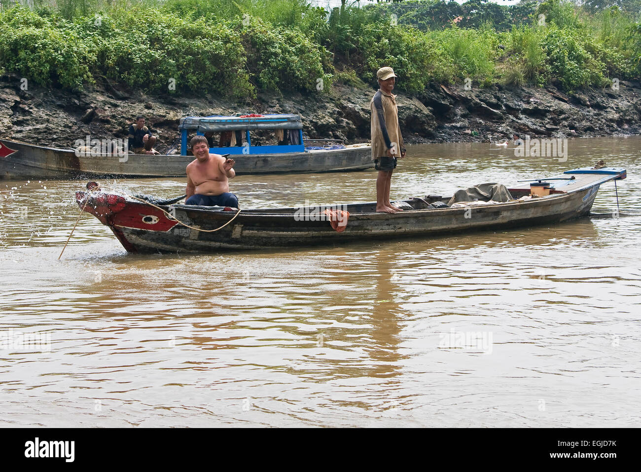 Vietnamese men on a boat on the saigon river hi-res stock photography ...