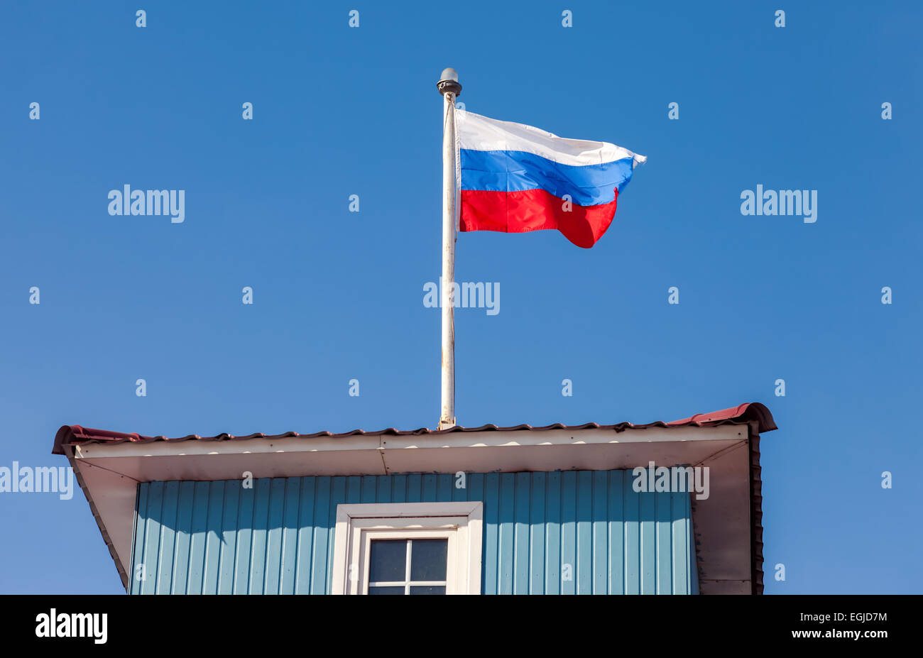 Russian flag waving in the wind over blue sky Stock Photo