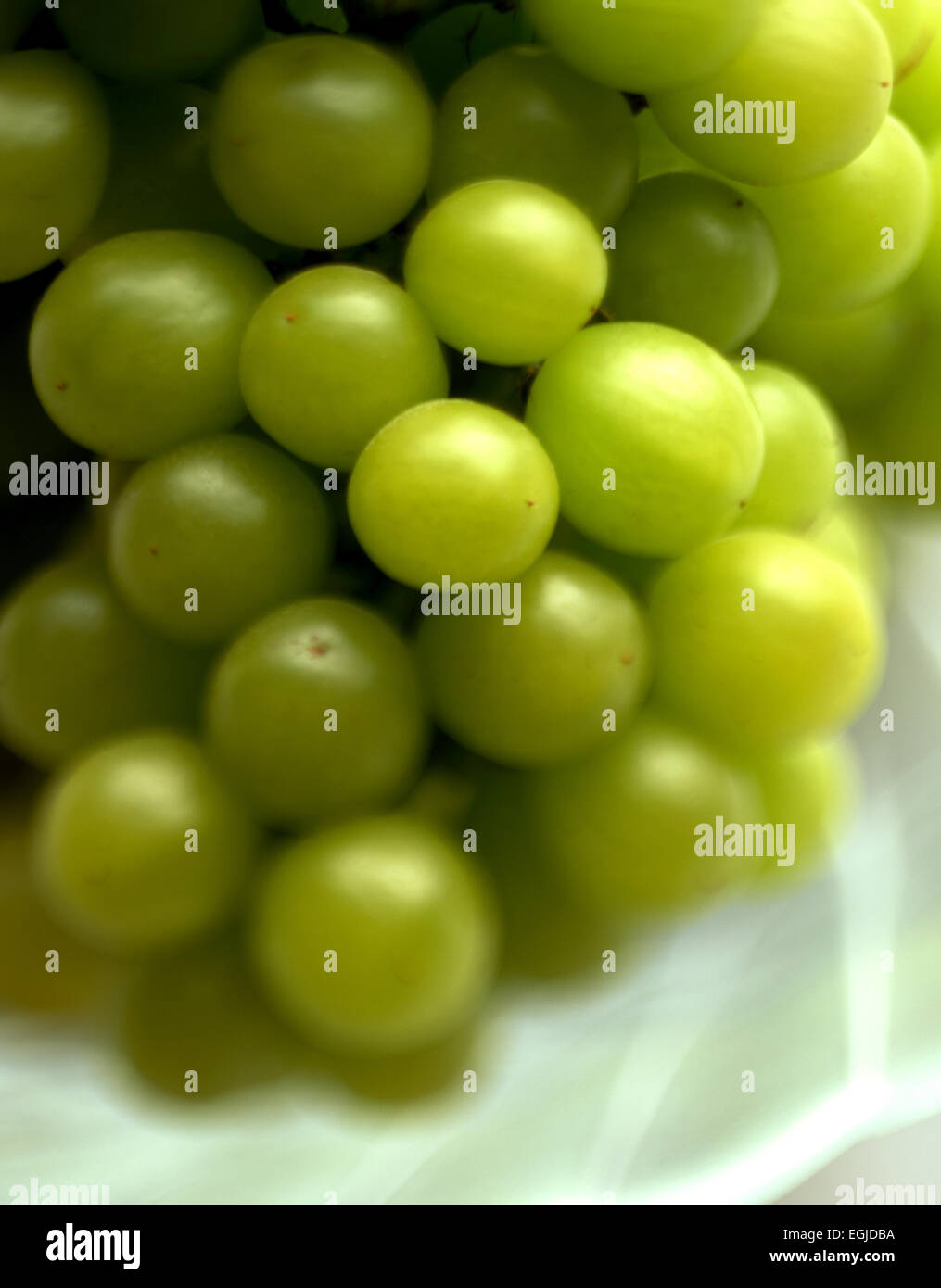 WHITE GRAPES IN A GLASS BOWL Stock Photo