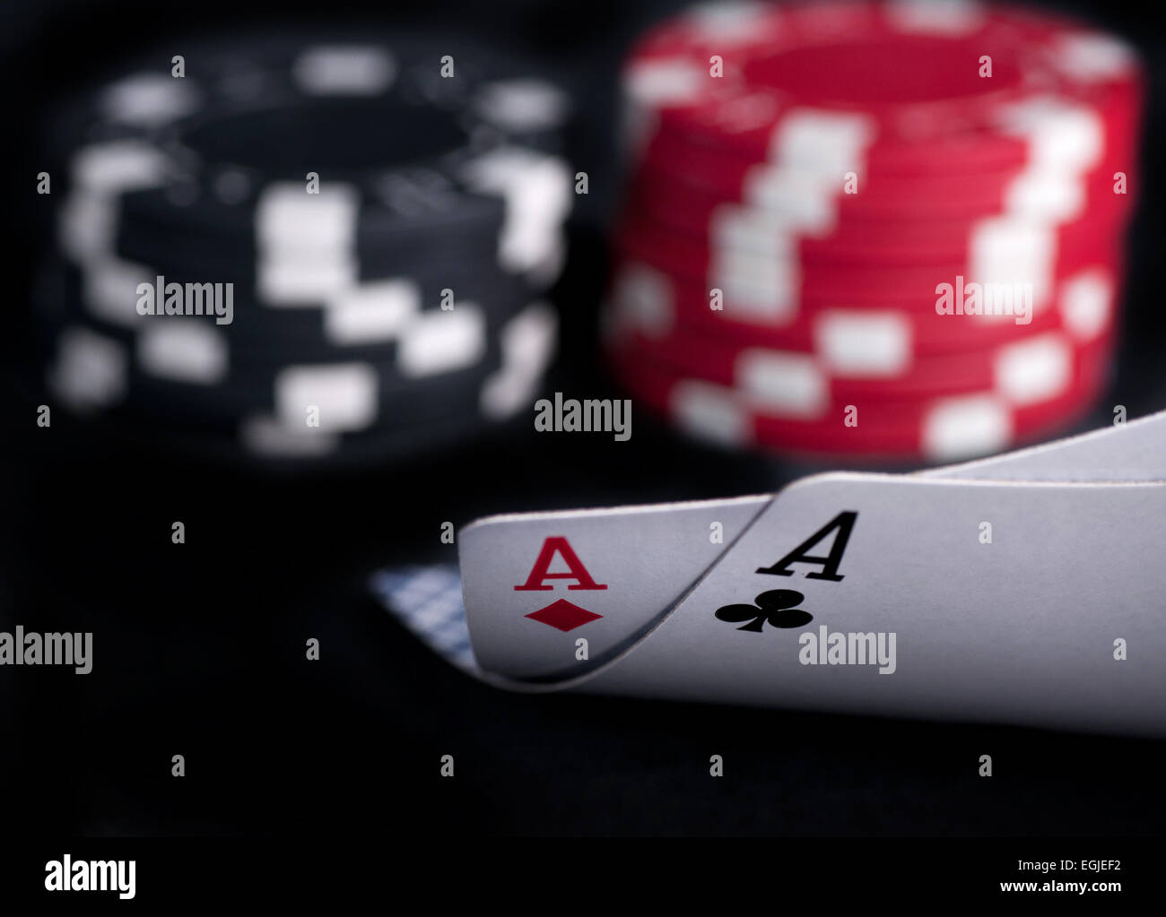 two aces high on black table with chips Stock Photo - Alamy