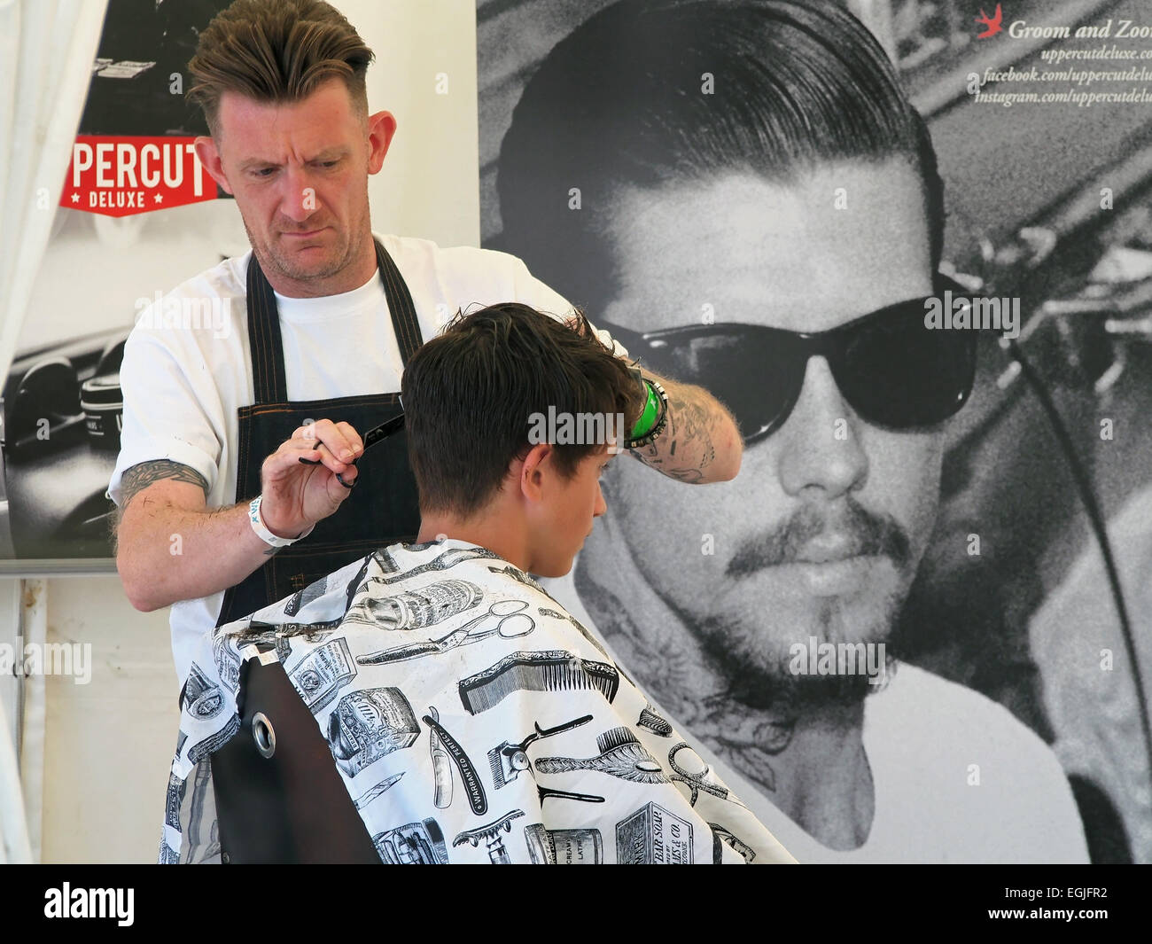 Pop up hairdresser for men at music festival UK Stock Photo