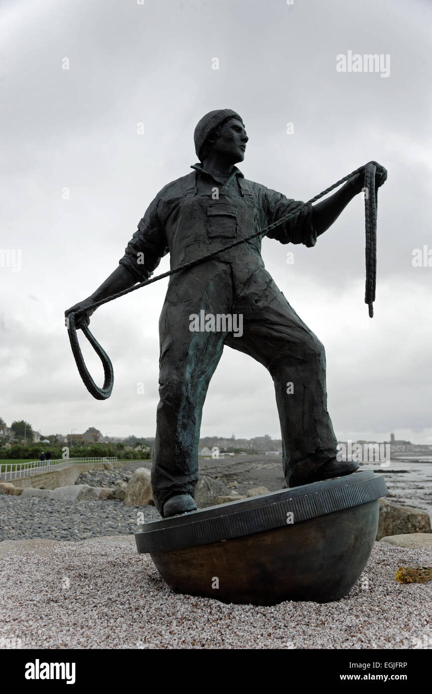 Lost at Sea monument with Statue of fisherman casting a rope, bronze situated on seafront Newlyn Cornwall UK Stock Photo