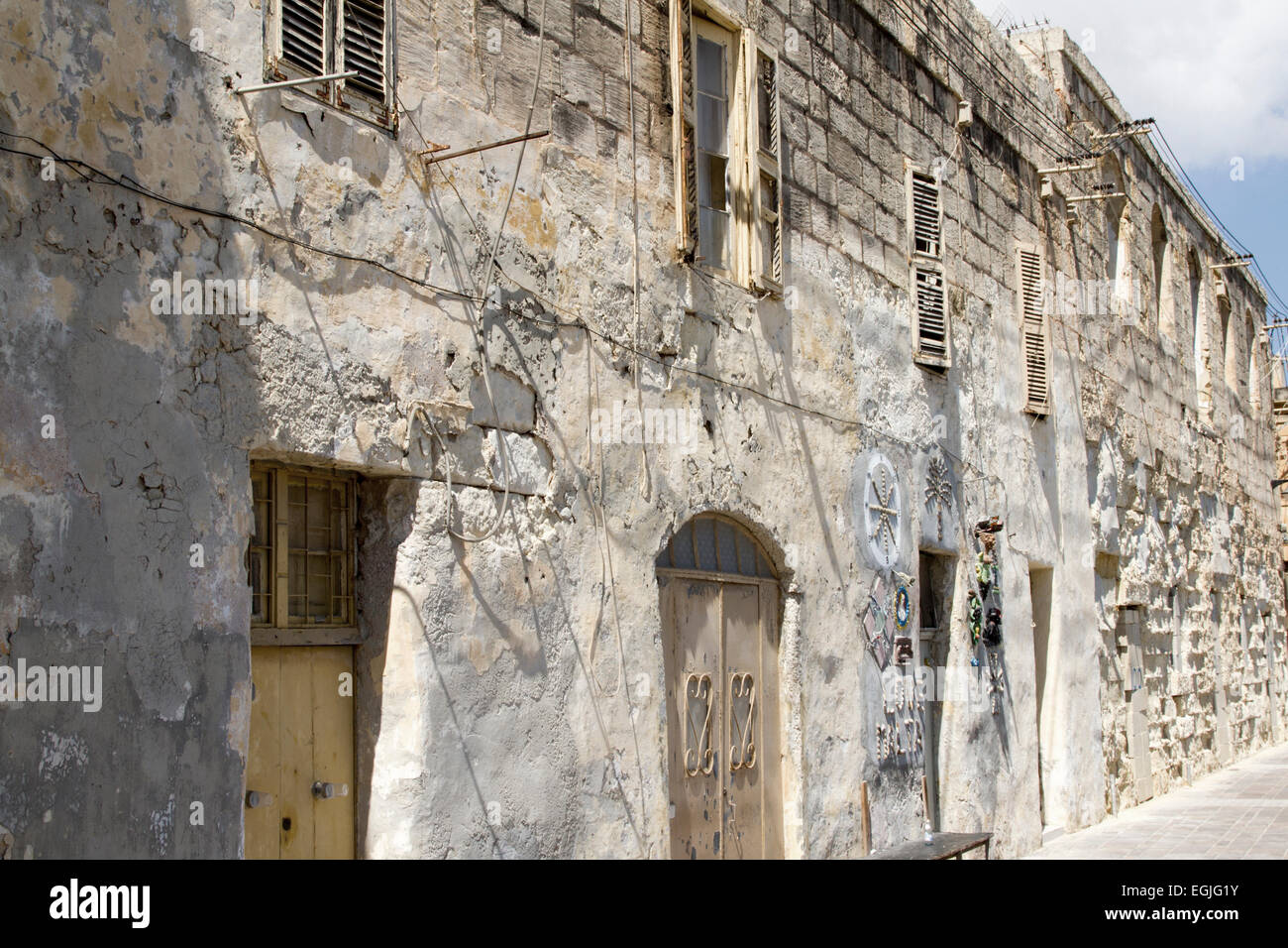 Old brick wall in a street in Marsaxlokk, Malta Stock Photo
