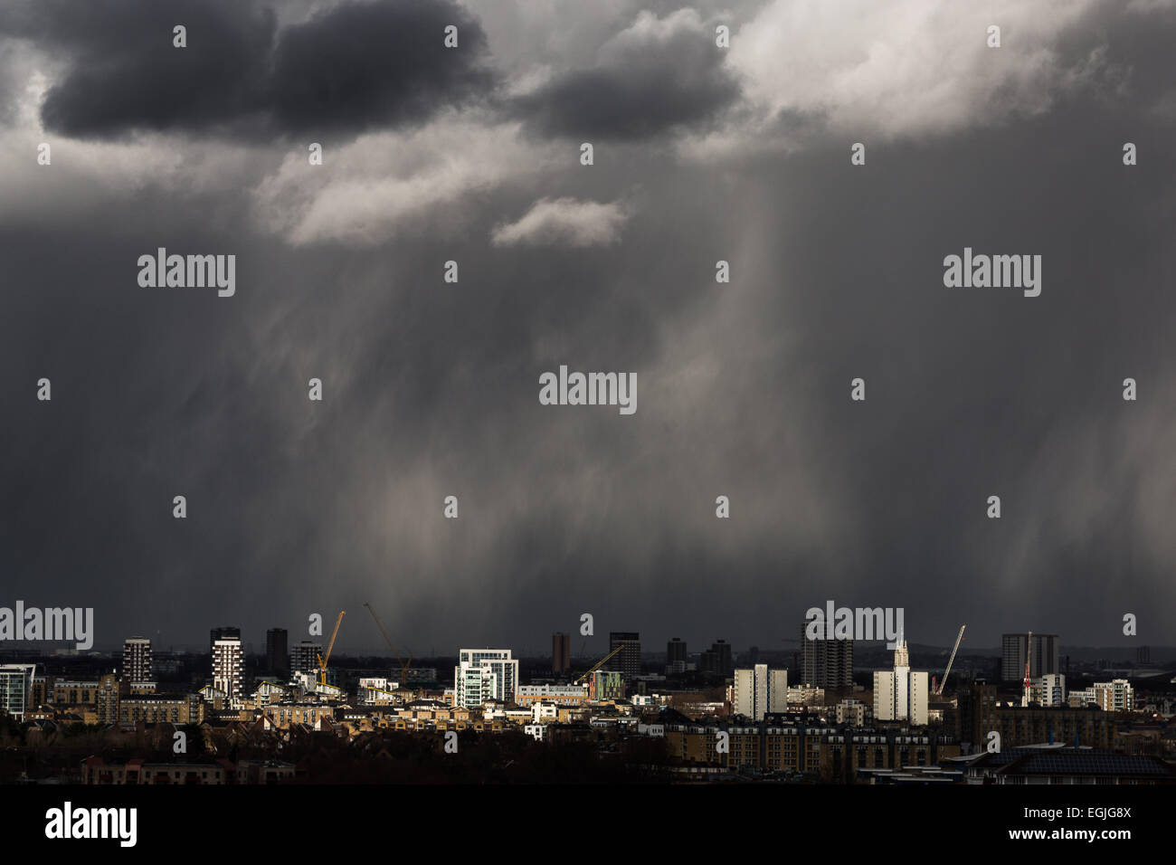 Dark storm clouds, heavy rain with sun break moves across central London Stock Photo