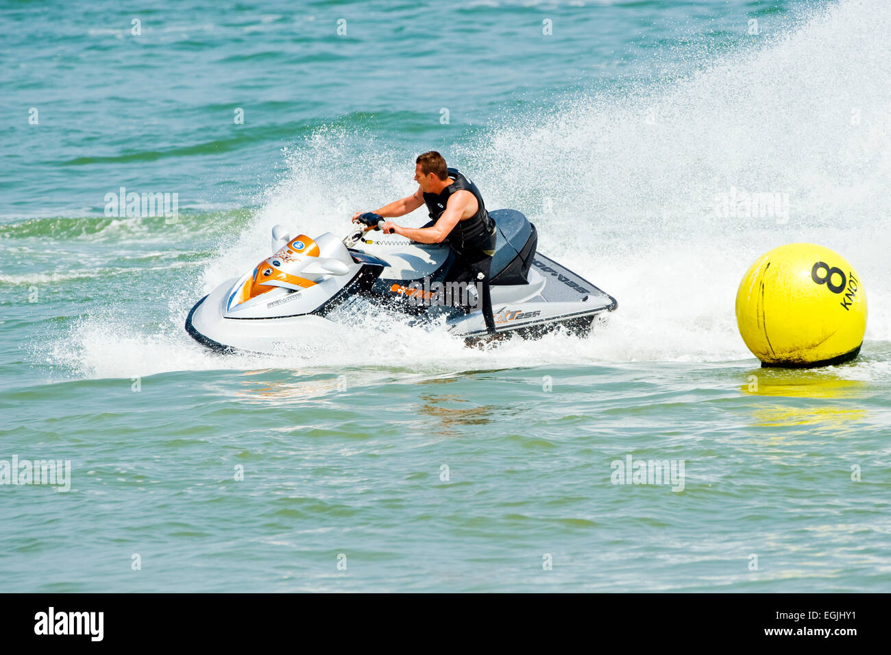 Man creating a splash on jet ski Stock Photo Alamy