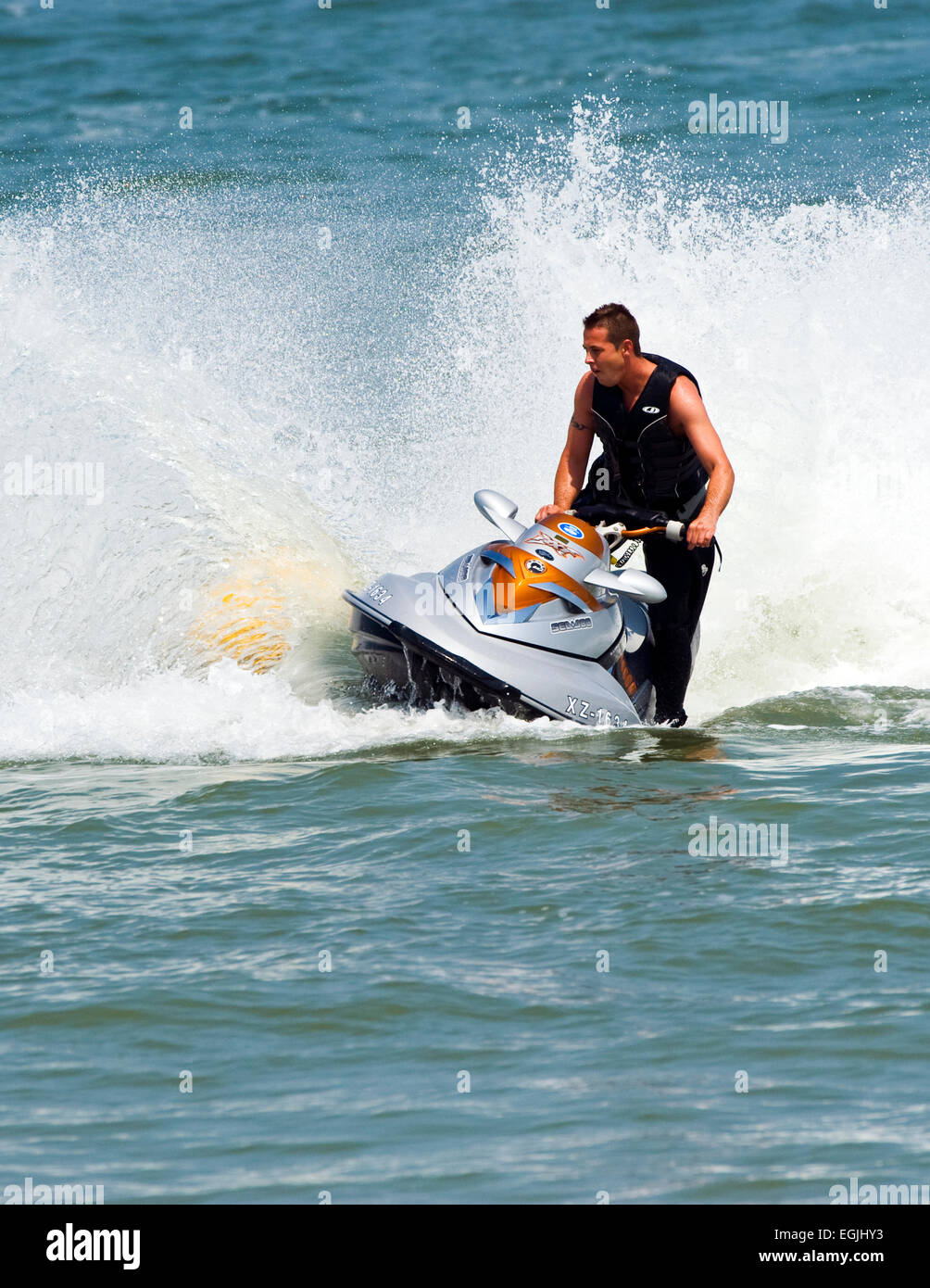 Man creating a splash on jet ski Stock Photo Alamy