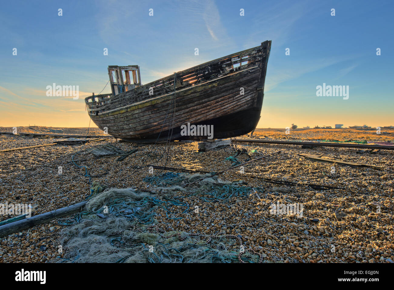 An hdr image of an abandoned and wrecked boat on a shingle beach Stock Photo