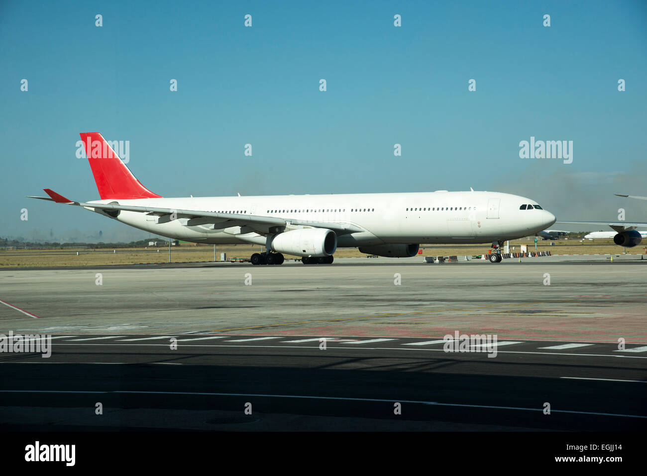Twin engine passenger jet aircraft taxiing along taxiway Stock Photo