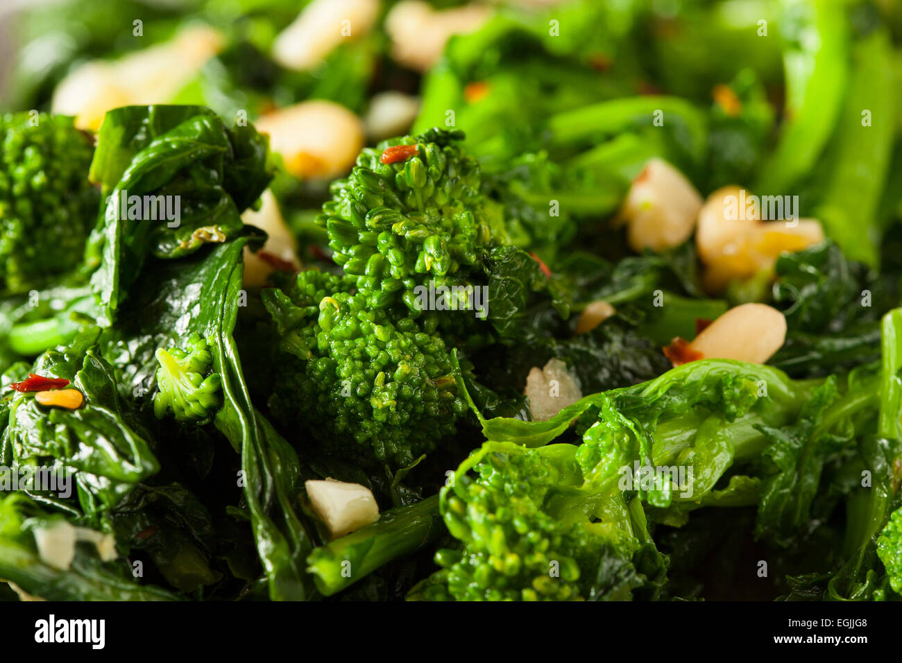 Homemade Sauteed Green Broccoli Rabe with Garlic and Nuts Stock Photo