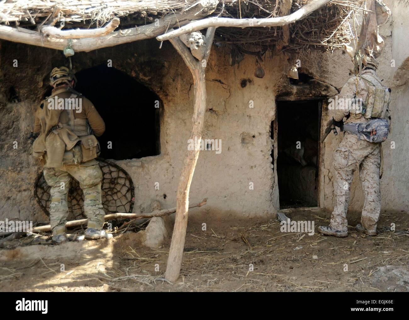 US Special Operation commandos check a compound during a security patrol February 6, 2013 in Doan-e Ulya Village, Shahid-e Hasas district, Uruzgan province, Afghanistan. Stock Photo