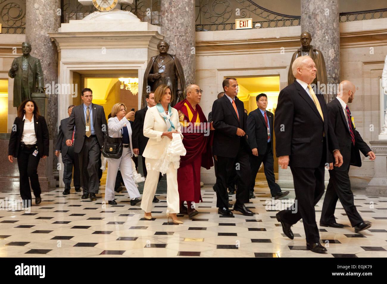 US Speaker of the House John Boehner and Democratic Leader Nancy Pelosi escort the Dalai Lama to a press conference following their meeting on Capitol Hill July 7, 2011 in Washington, DC. Stock Photo