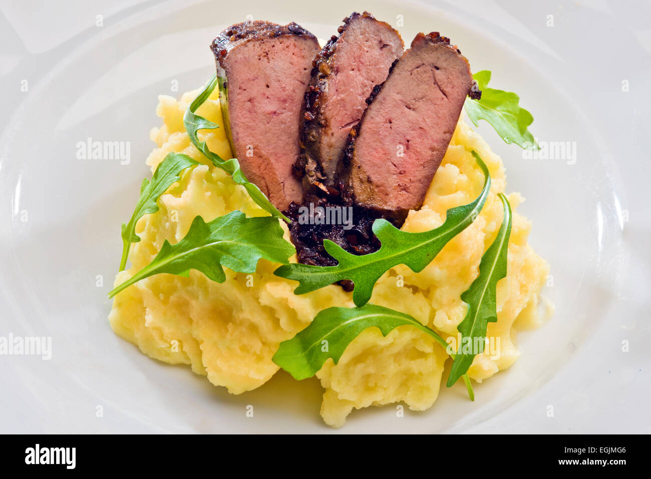 Spice crusted veal liver sliced to with balsamic vinegar caramelized