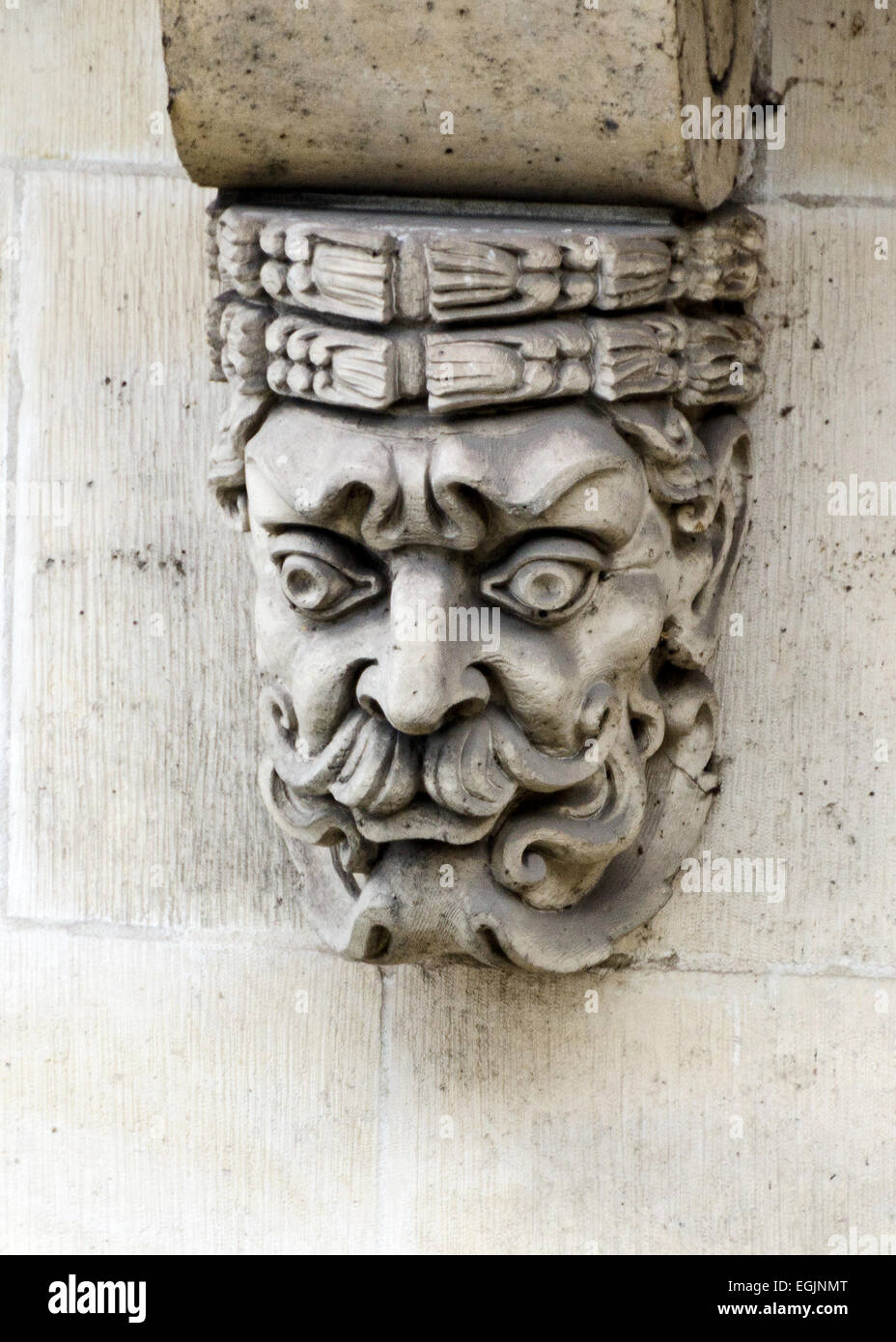 A carved face ornaments a corbel below the Pont Neuf, Paris, France. Stock Photo