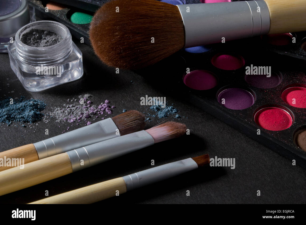 Various makeup products on a black background Stock Photo