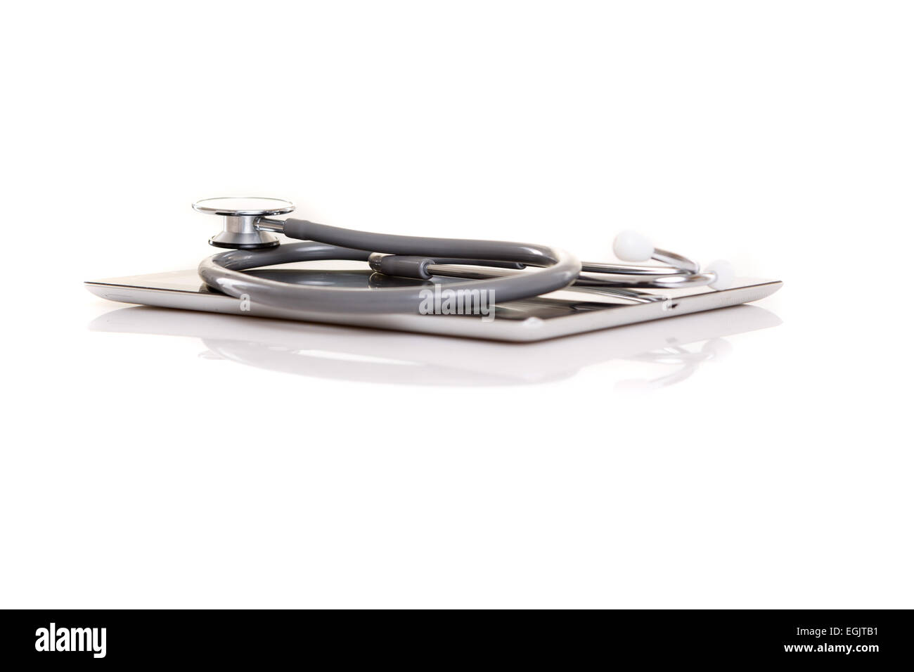 Stethoscope over a tablet computer, isolated over white background ...