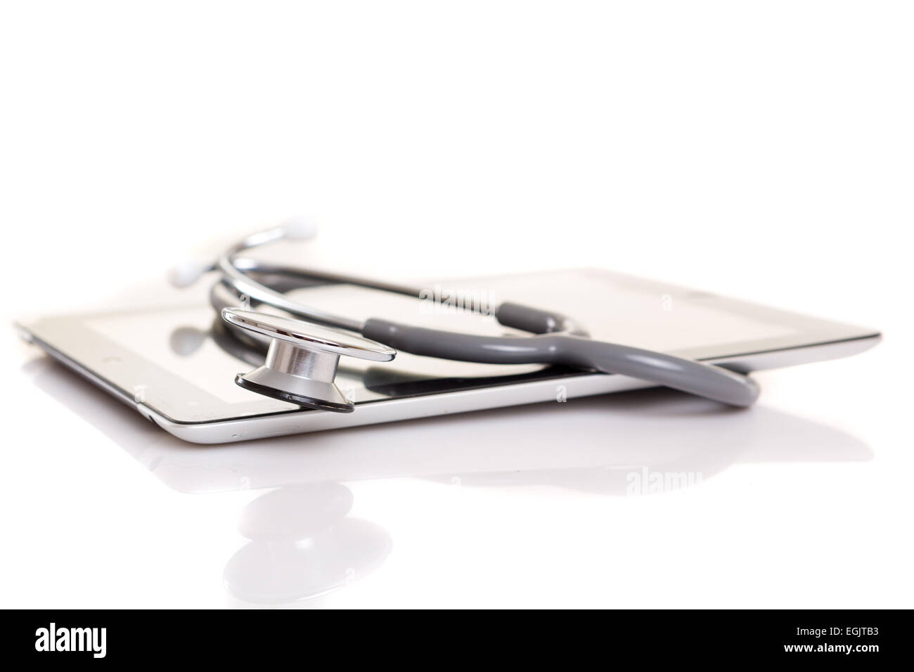 Stethoscope over a tablet computer, isolated over white background ...