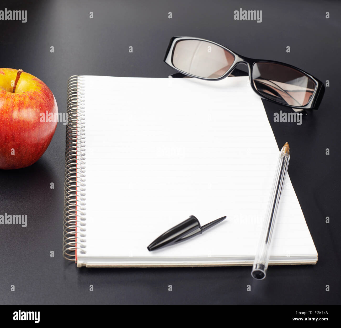 Apple, glasses and note book Stock Photo Alamy