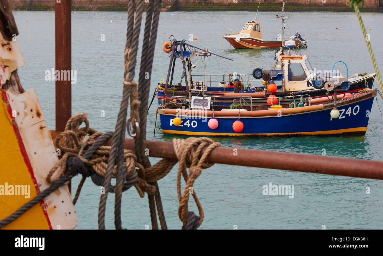 Fishing boats seen through old mooring ropes from Smeaton's Pier St Ives Cornwall England Europe Stock Photo