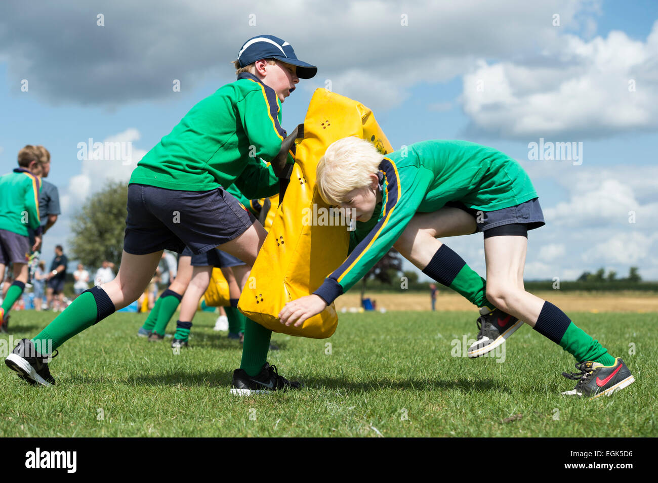 North Dorset RFC Open Day. Boys practising with tackle bag Stock Photo