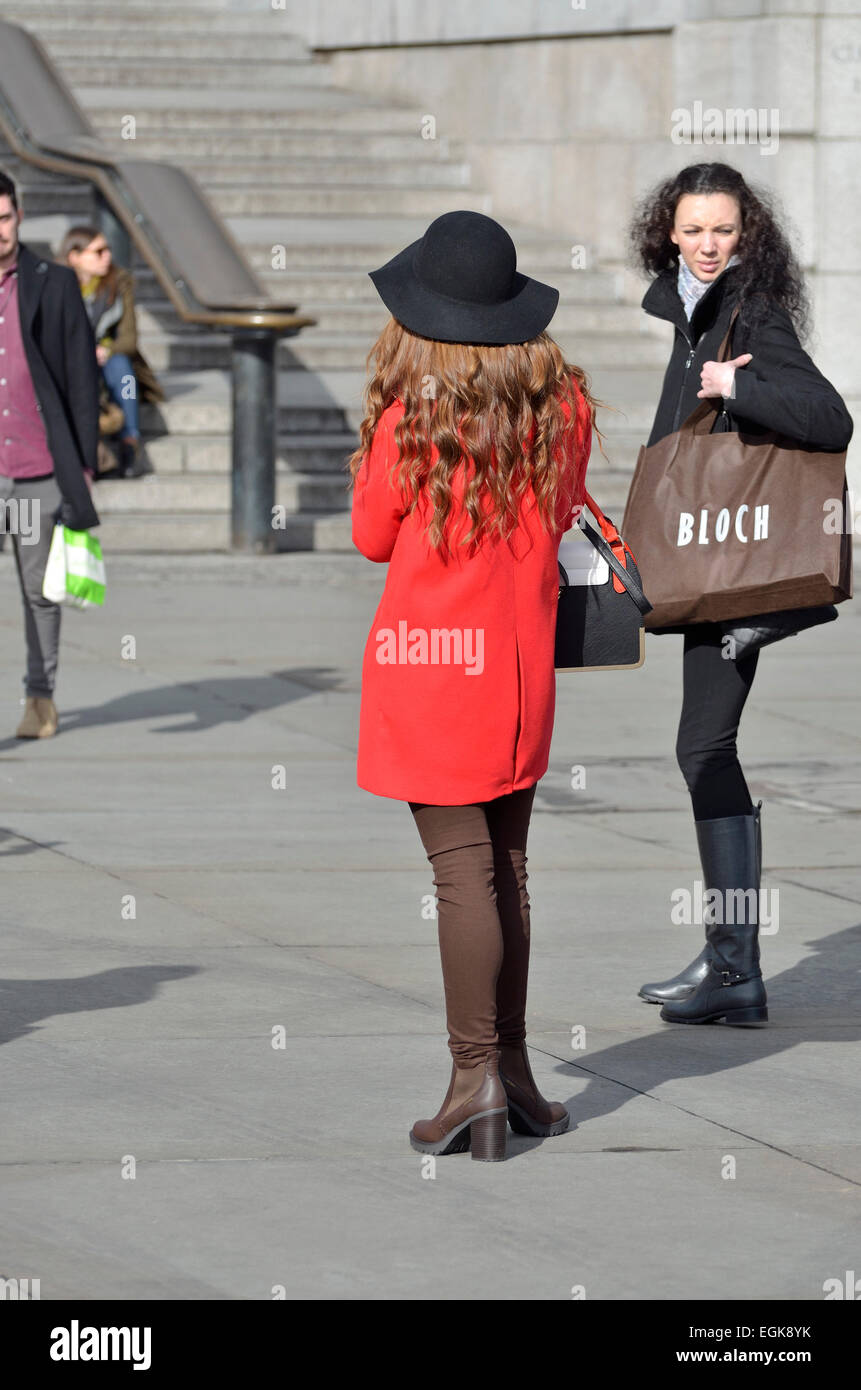 London, England, UK. Two well-dressed young women in Trafalgar Square Stock Photo