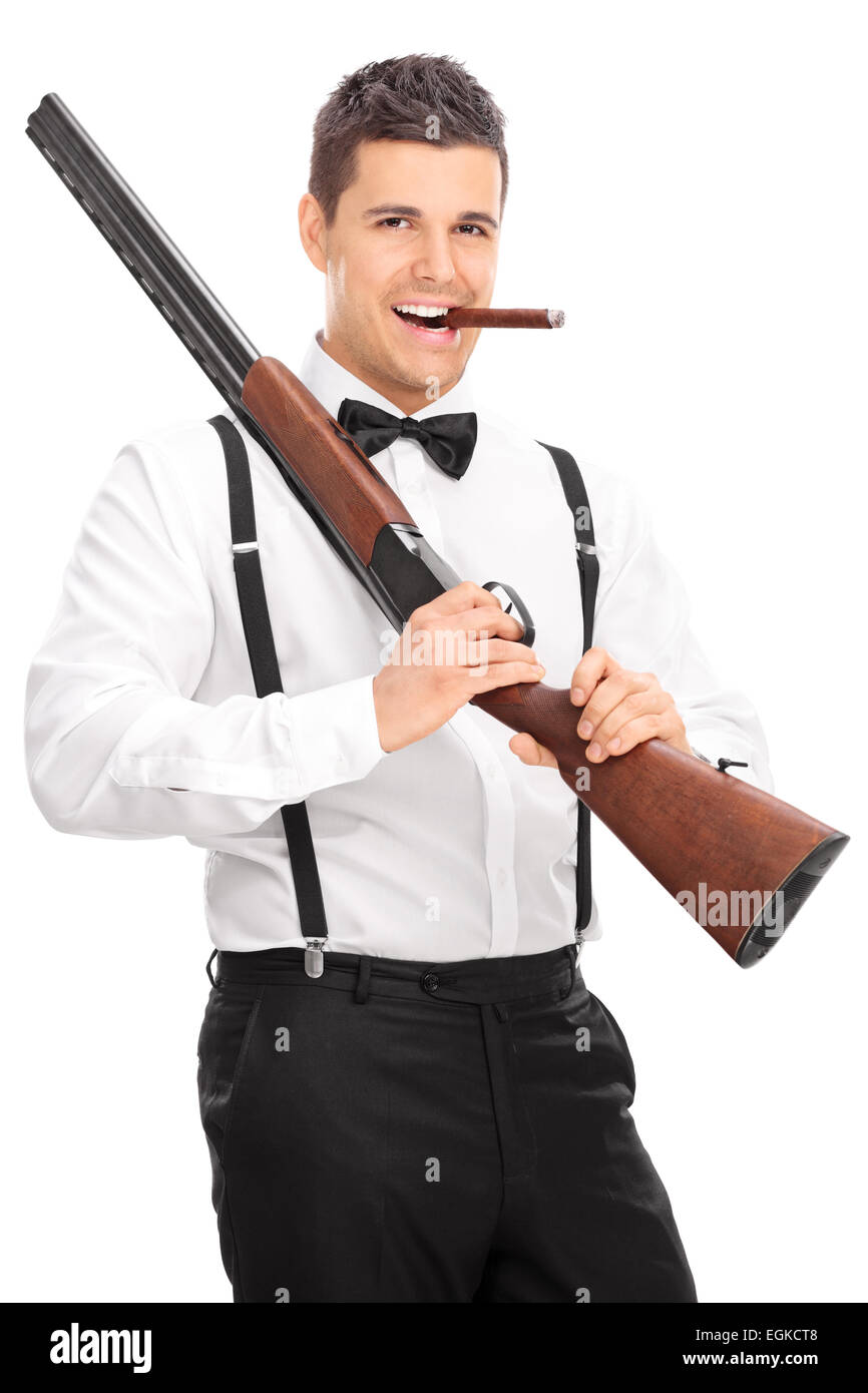 Young man holding a rifle and smoking cigar isolated on white background Stock Photo