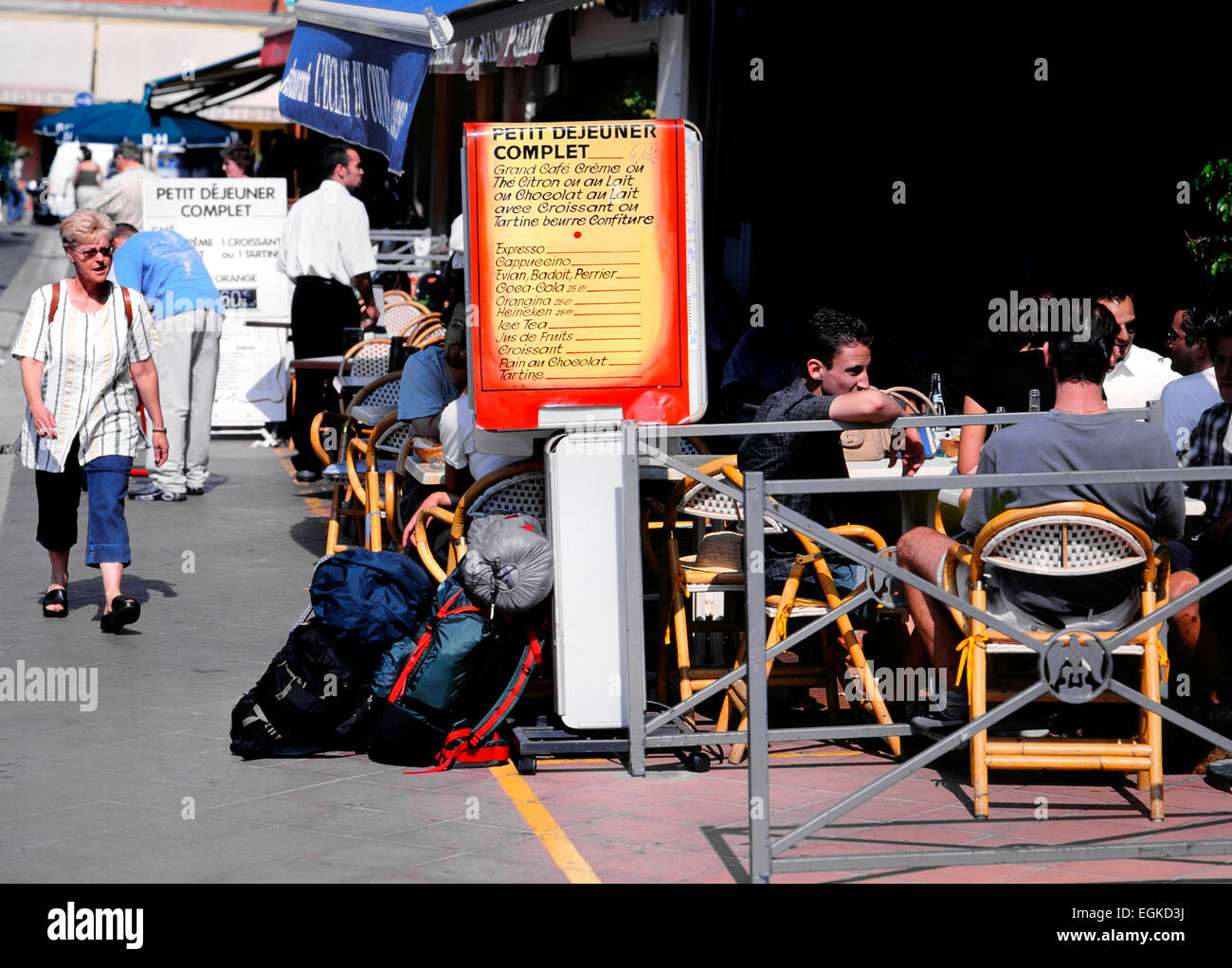 Nice, Cote d'Azur, France. Place Charles Felix, backpackers sitting outside cafe. Breakfast menu Stock Photo
