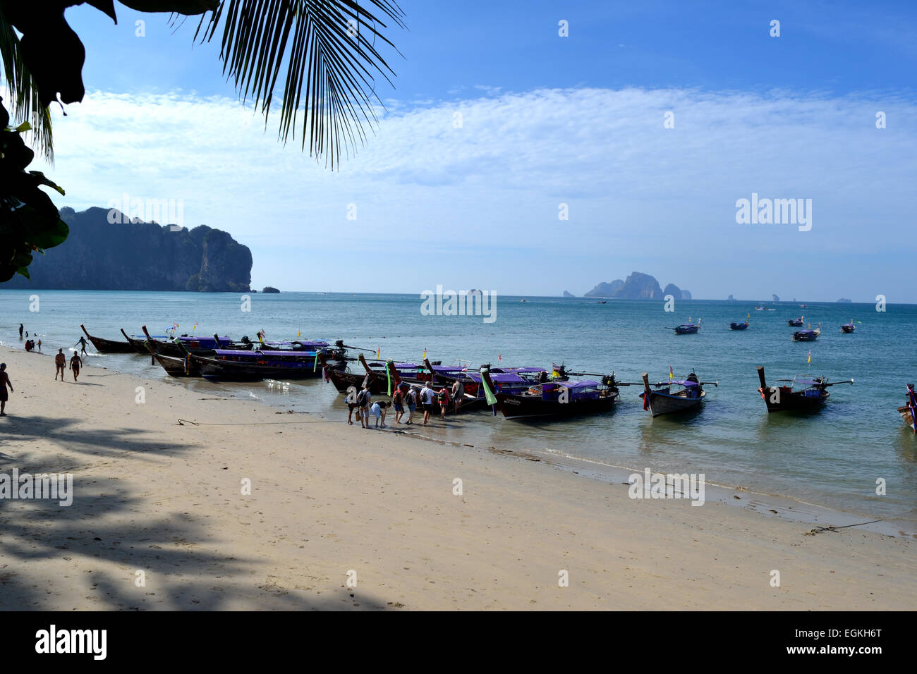 Long Tail Boats anchored at Railay Beach waiting to take day trippers back to Krabi Stock Photo