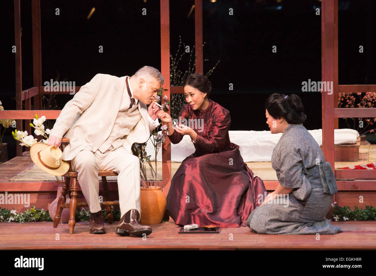 London, UK. 25 February 2015. L-R: David Kempster as Sharpless, Hyeseoung Kwon as Cio Cio San/Butterfly and Sabina Kim as Suzuki. Dress rehearsal of the Puccini opera 'Madam Butterfly', staged in the round of the Royal Albert Hall. The opera is performed from 26 February to 15 March 2015. Directed by David Freeman with Oliver Gooch conducting the Royal Philharmonic Orchestra. Cast includes: Hyeseoung Kwon as Cio Cio San/Butterfly, Jeffrey Gwaltney as Pinkerton, David Kempster as Sharpless, Sabina Kim as Suzuki, Michael Druiett as The Bonze, Julius Ahn as Goro and Lise Christensen as Kate Pinke Stock Photo