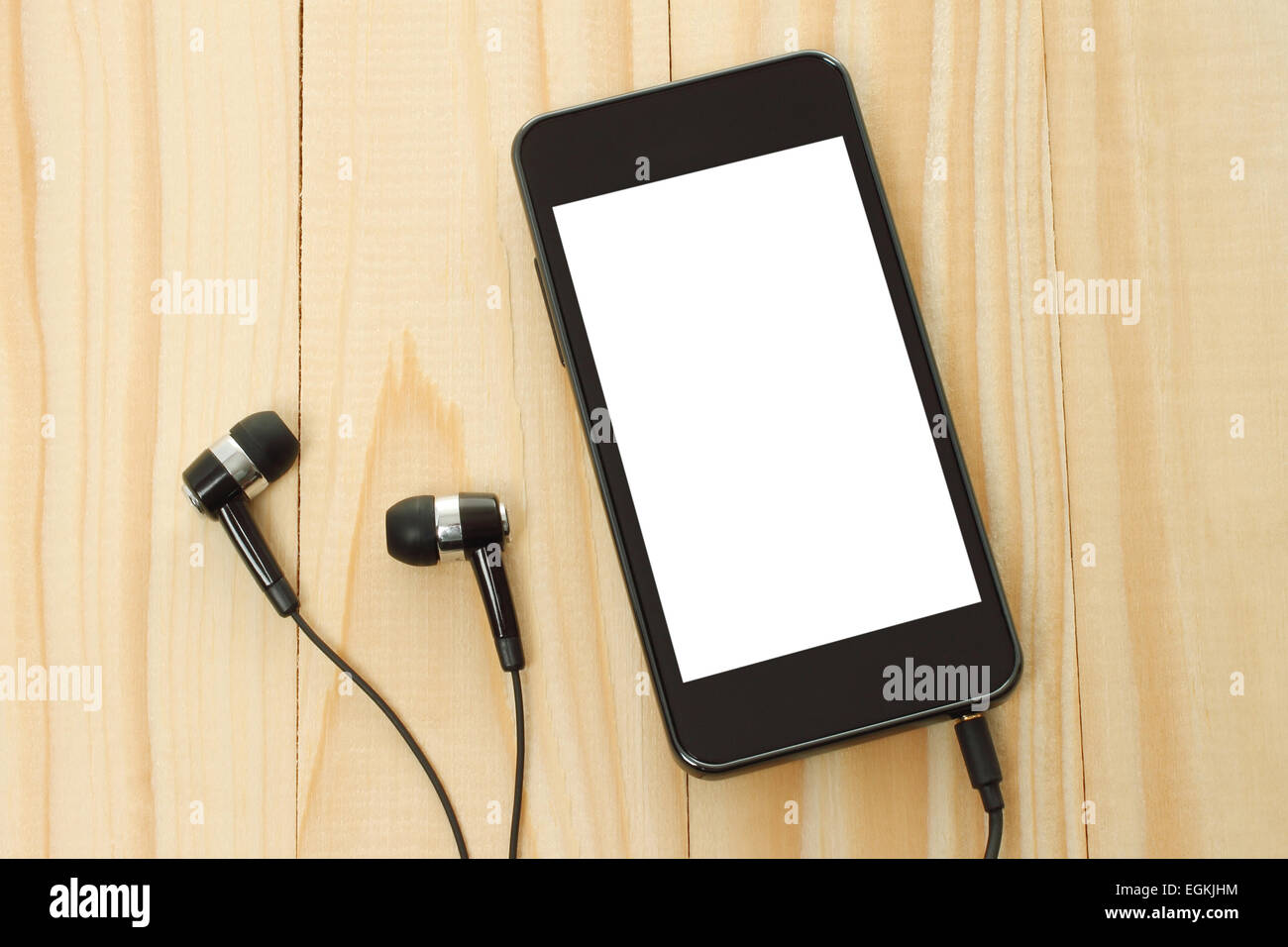 Smart phone with headphones on wooden background Stock Photo
