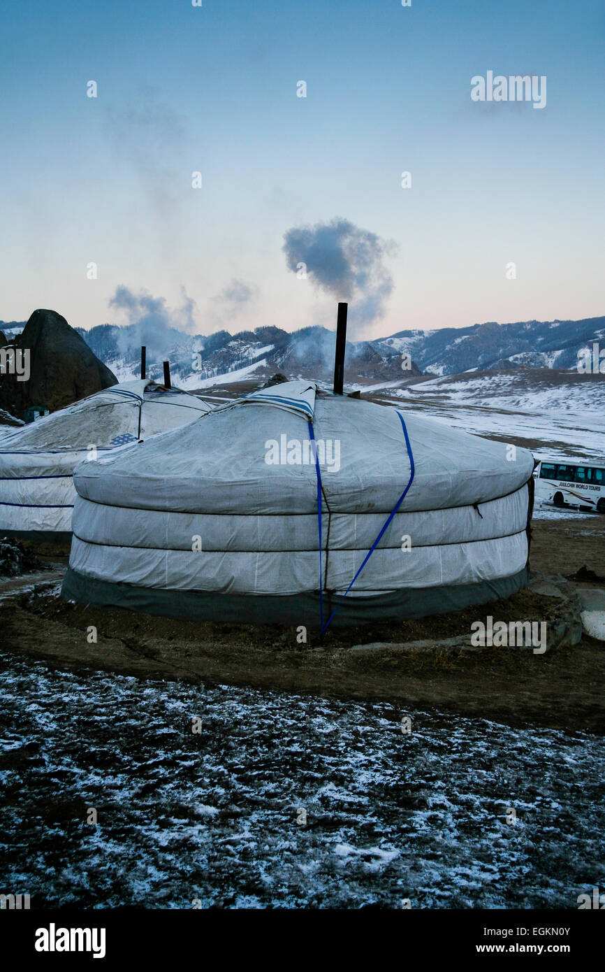 MONGOLIA Pair of traditional yurt tents with smoke rising from chimneys. Stock Photo