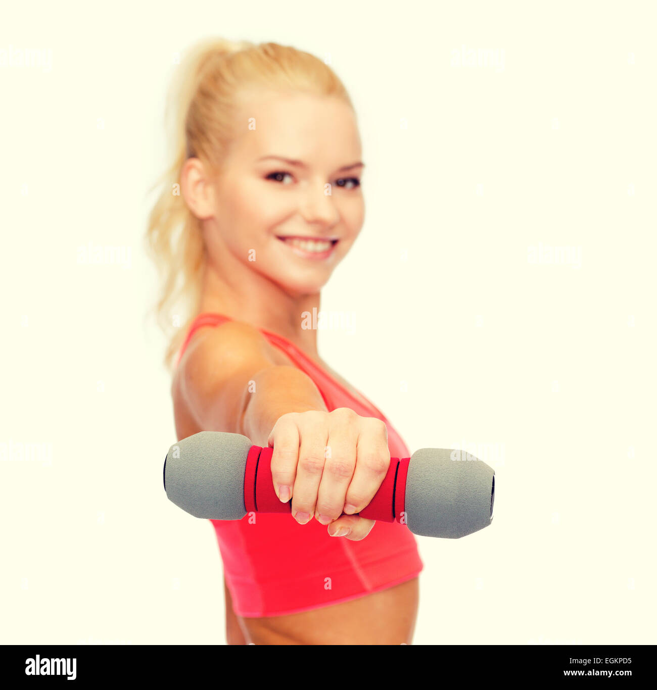 smiling beautiful sporty woman with dumbbell Stock Photo