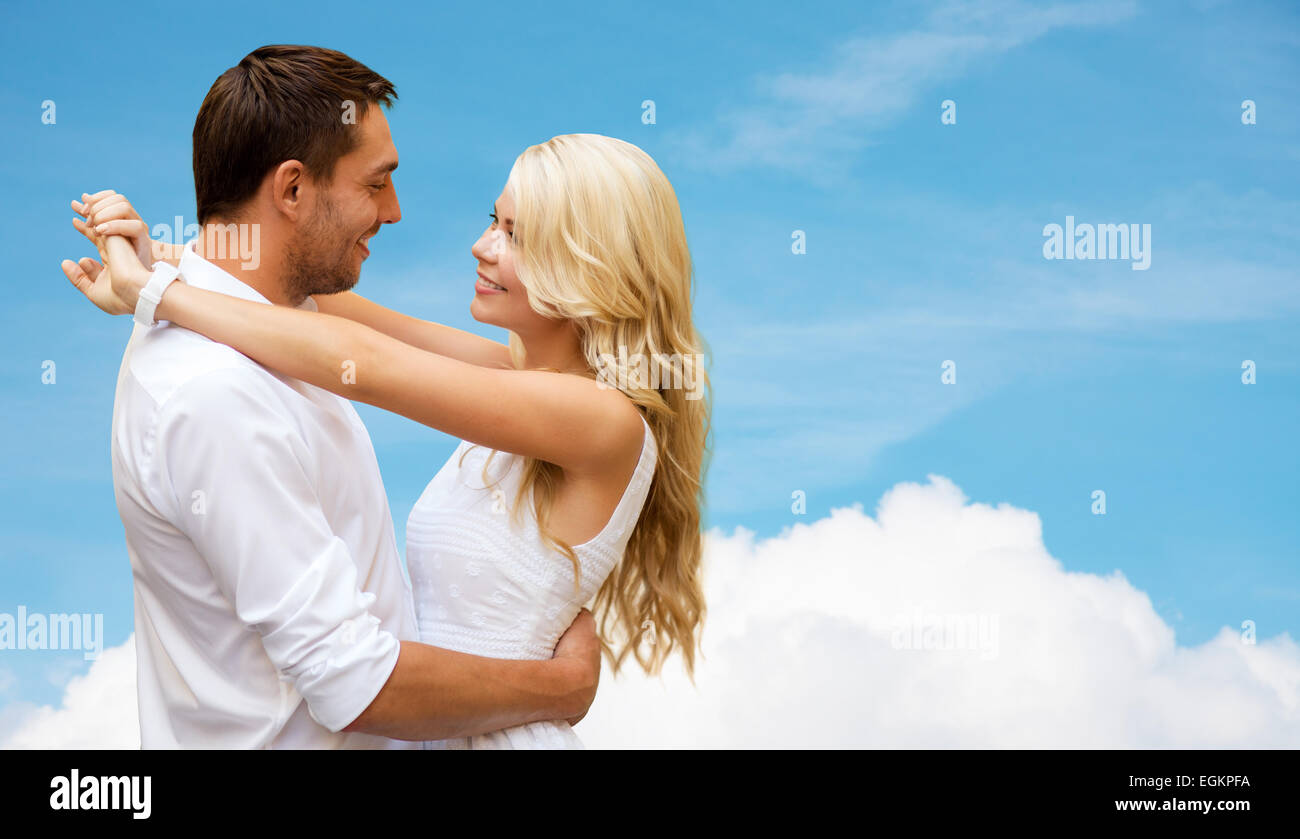 happy couple hugging over blue sky and cloud Stock Photo - Alamy