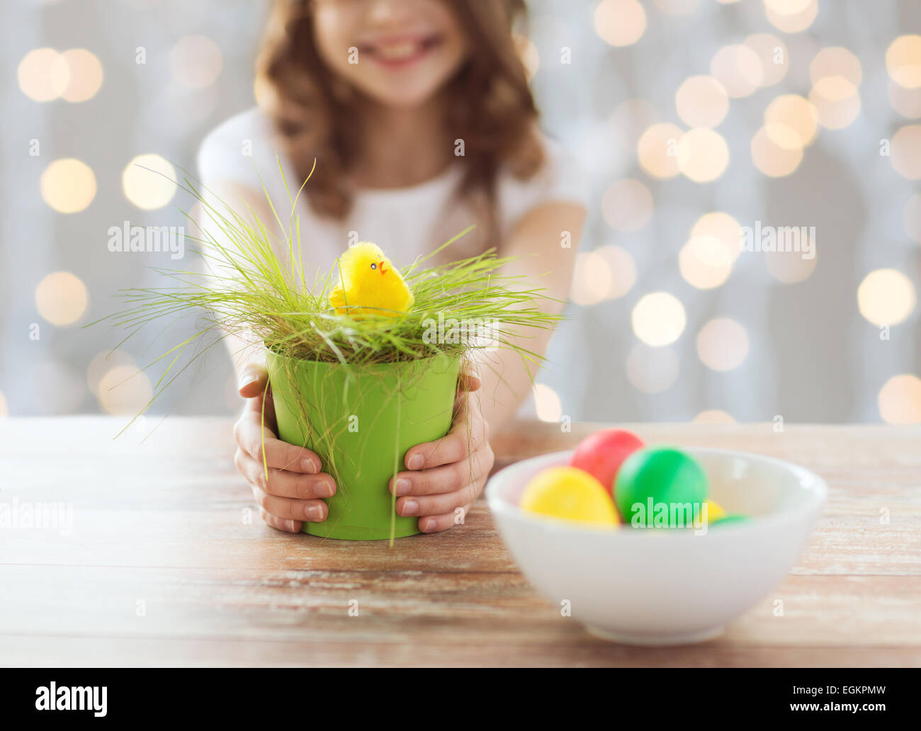 close up of girl holding pot with easter grass Stock Photo