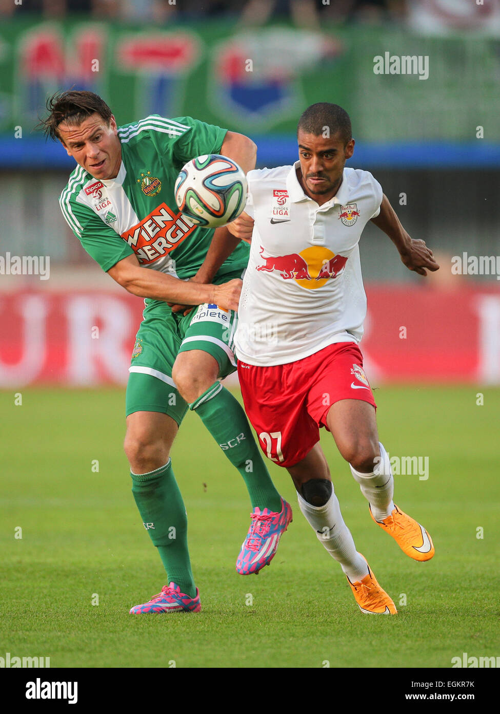 VIENNA, AUSTRIA - SEPTEMBER 28, 2014: Alan (#27 Salzburg) and Stefan Schwab (#8 Rapid) fight for the ball in an Austrian soccer Stock Photo