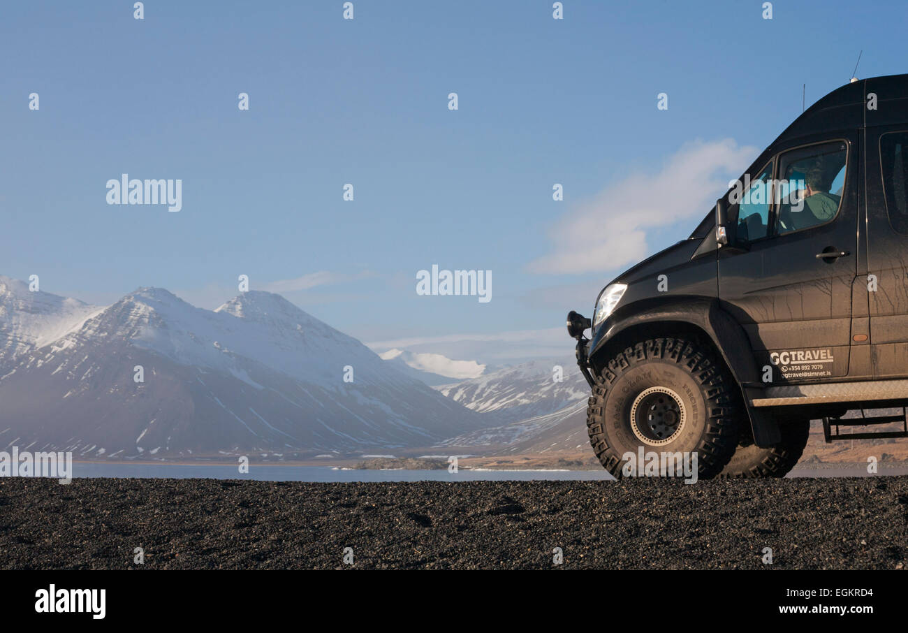 Super jeep stopped by the stunning scenery at Eystrahorn, South East Iceland in February Stock Photo