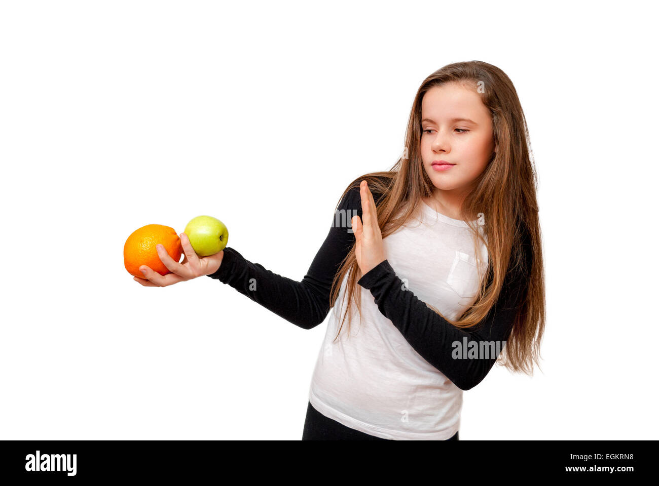 Thinking little girl with orange and apple isolated on white Stock Photo
