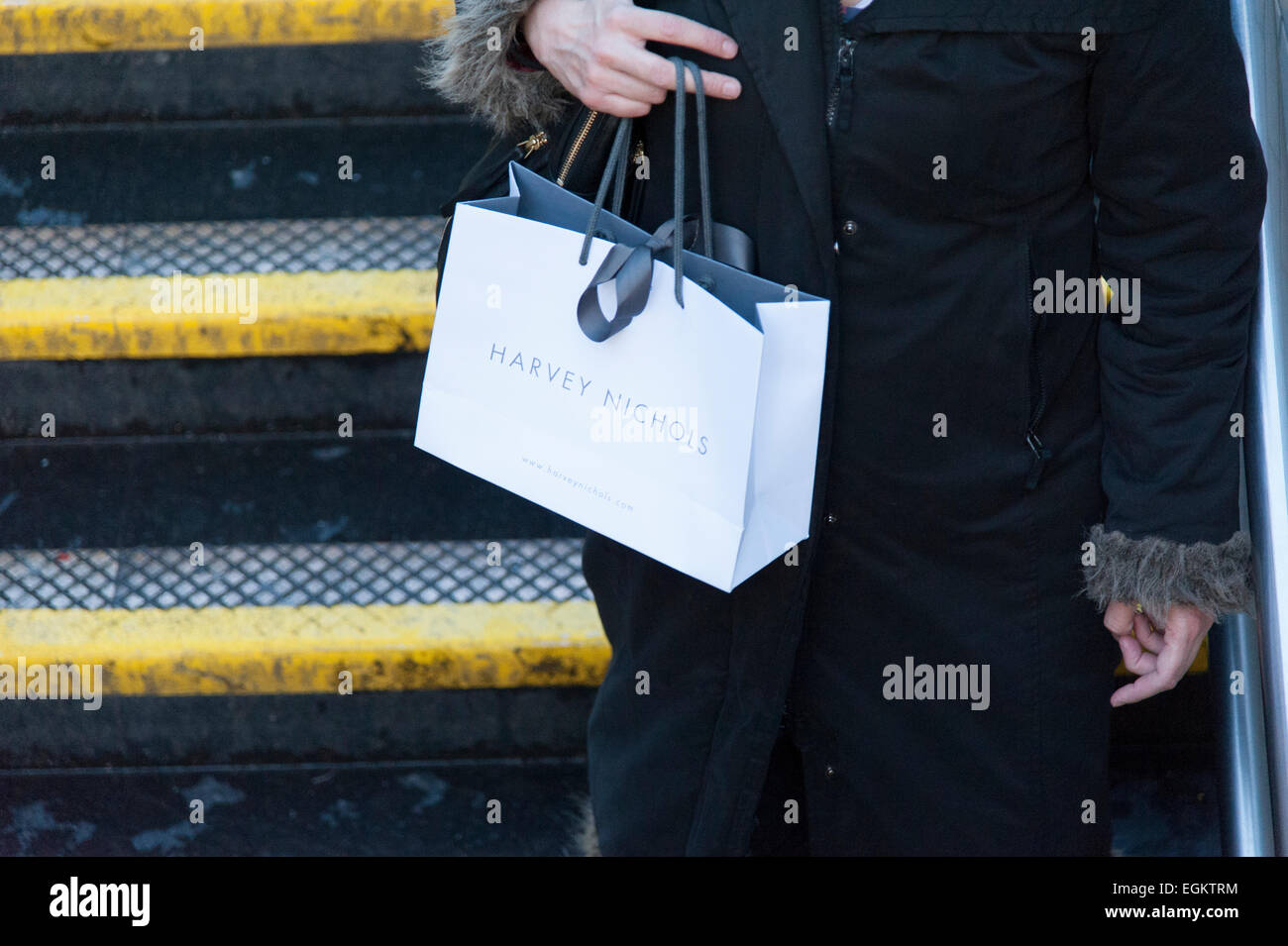 Female carrying Harvey Nichols bags outside the department store in Knightsbridge, London. Stock Photo