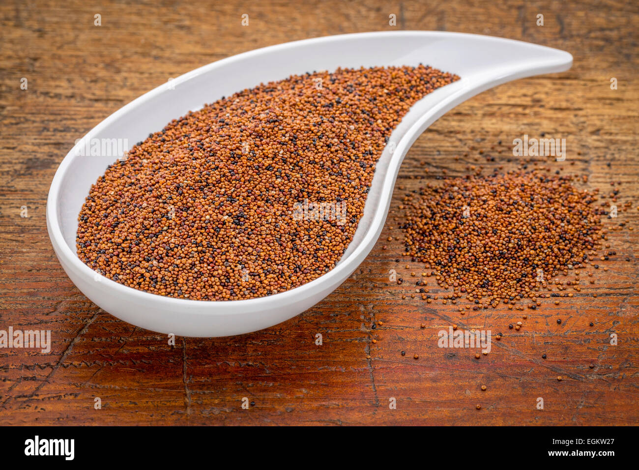 gluten free kaniwa grain on a white teardrop shaped bowl against rustic wood Stock Photo