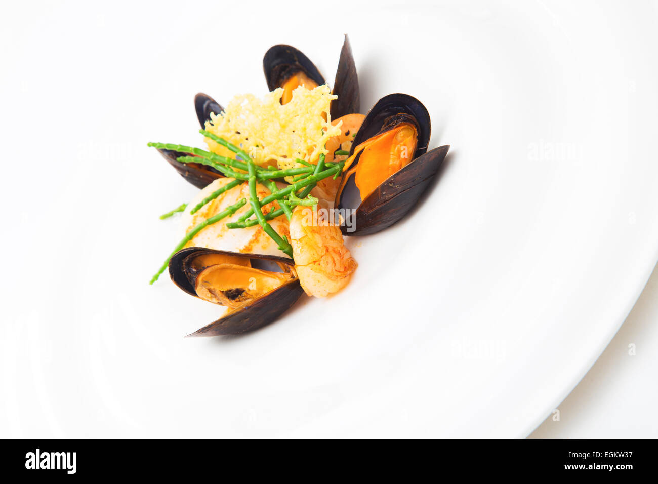 Mollusc and mussels appetizer prepared at a restaurant, isolated on white, vertical format Stock Photo