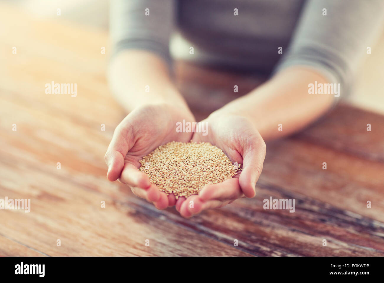 cloes uo of female cupped hands with quinoa Stock Photo