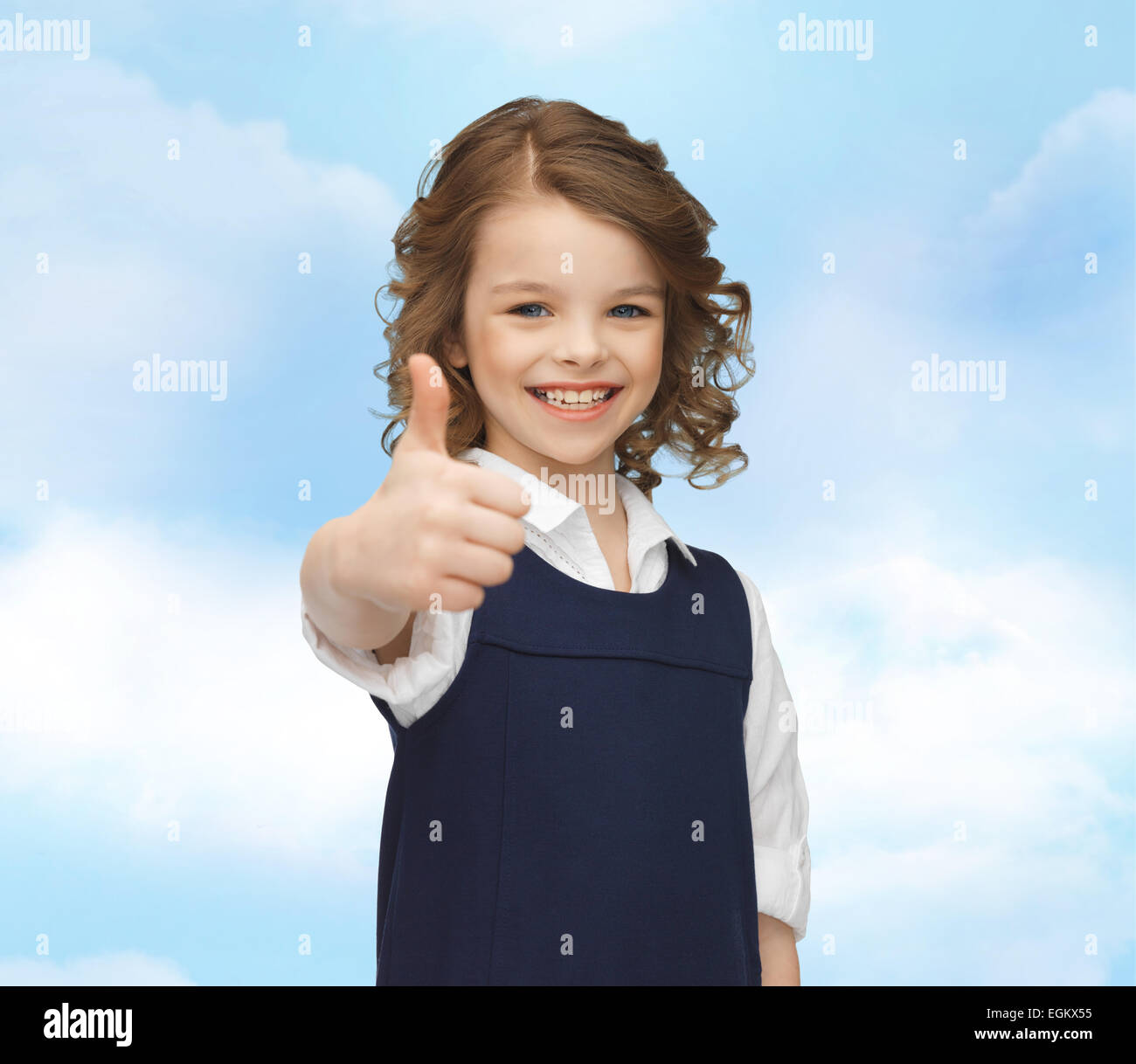 happy little school girl showing thumbs up Stock Photo - Alamy
