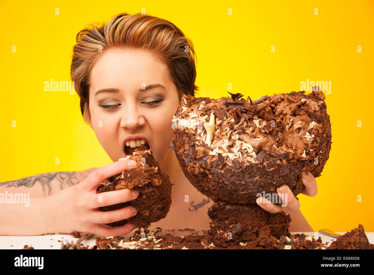 Young woman about to eat a large slice of chocolate cake. Stock Photo