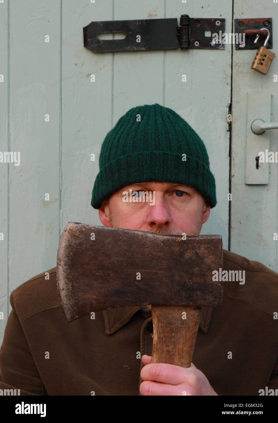 Man aged 50 years old wearing outdoor working clothes and holding an