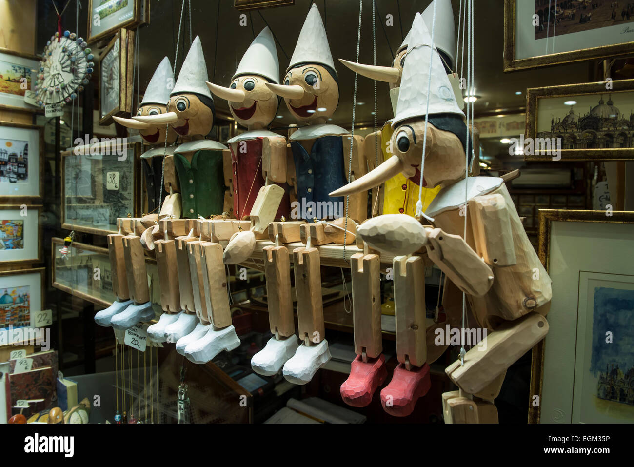 a series of wooden pinocchio puppets sitting in a row Stock Photo