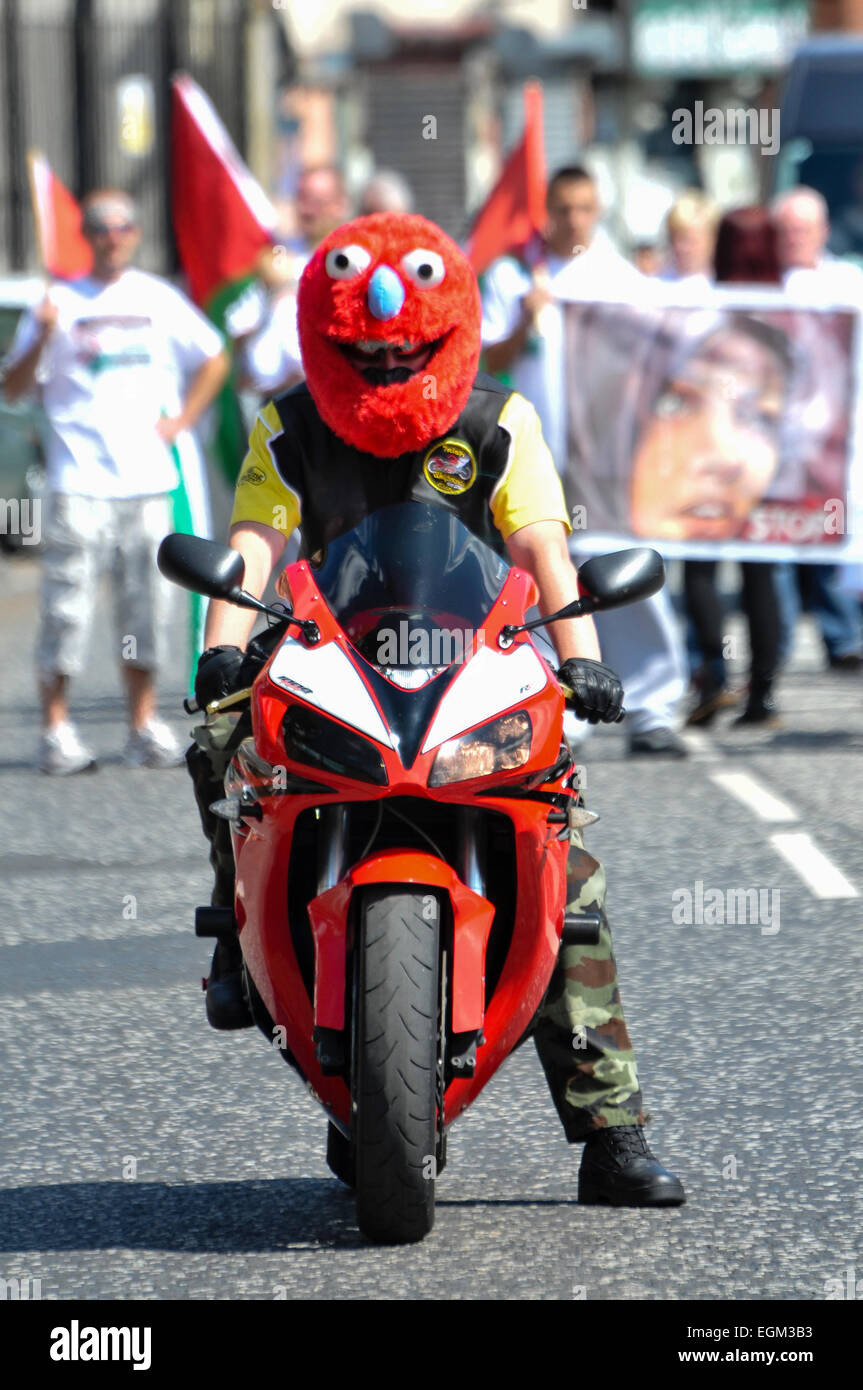 Belfast, Northern Ireland. 3 Aug 2014 - A man wears an Elmo muppet helmet  while he rides a motorcycle Stock Photo - Alamy