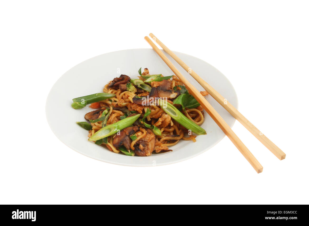 Chinese egg noodle stir fry in a bowl with chopsticks isolated against white Stock Photo