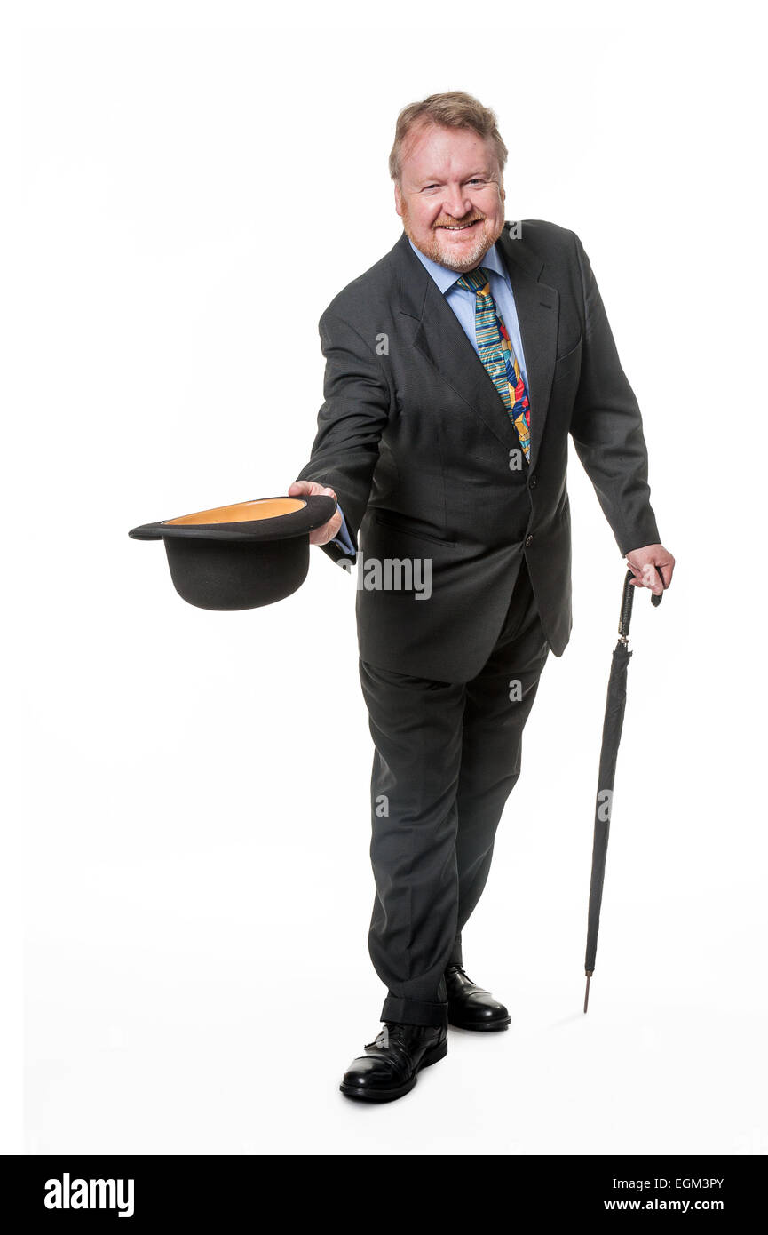 Happy middle aged man in suit holding bowler hat, with umbrella, isolated on white Stock Photo