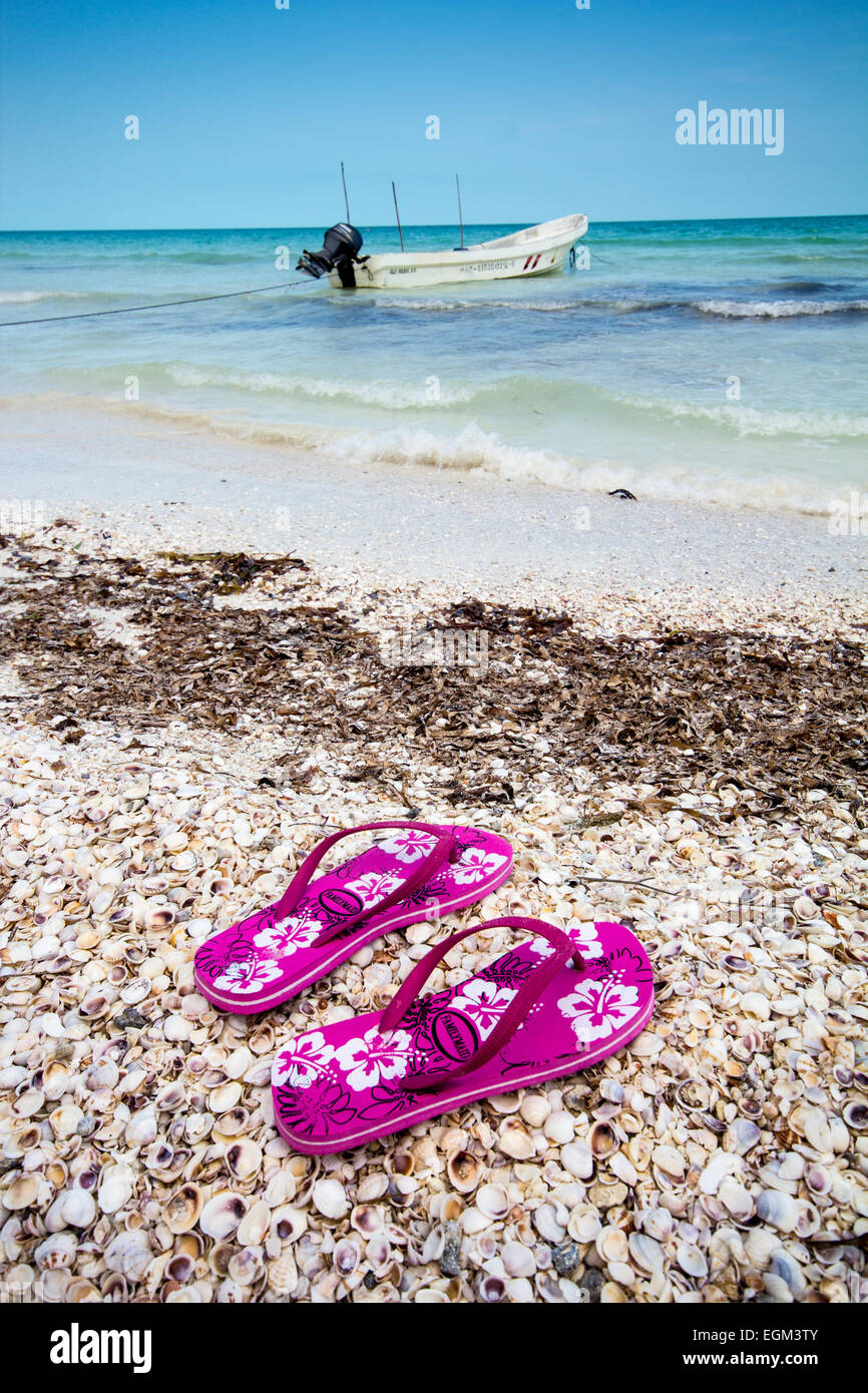 Pair of pink flipflops left behind on beach Stock Photo